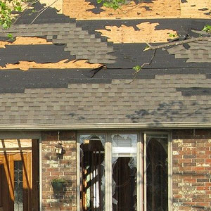Damaged roof, missing shingles, broken windows