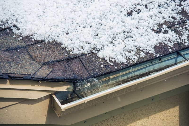 snow and hail on roof draining into gutters
