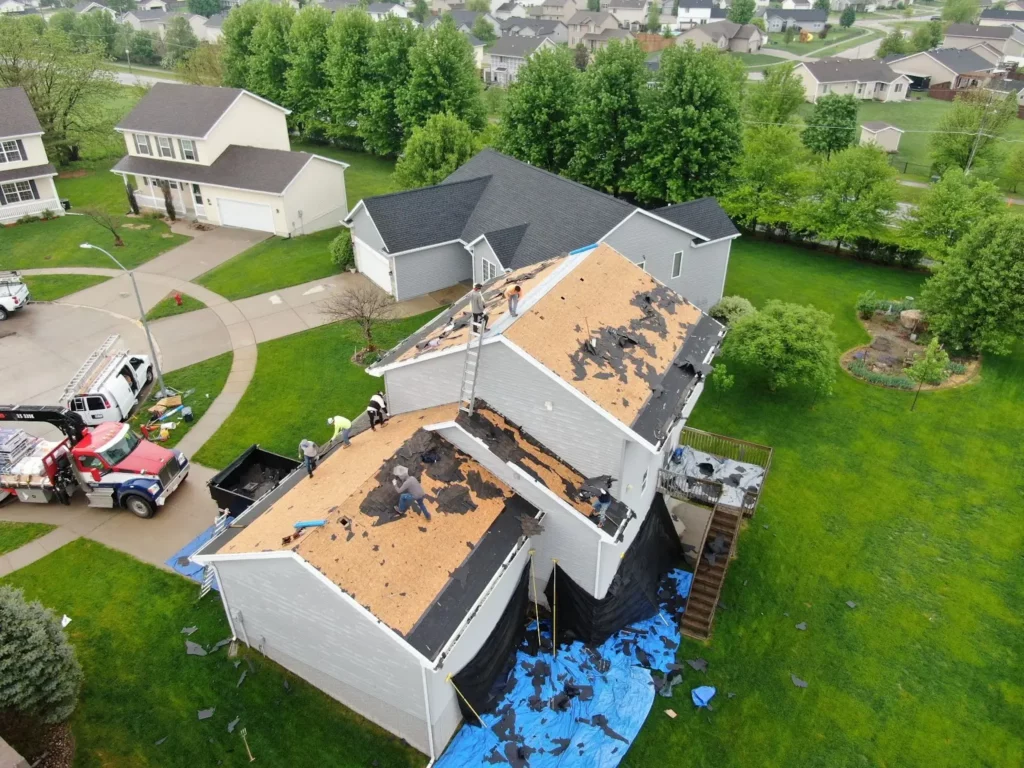 A roofing company replaces the roof on a suburban home