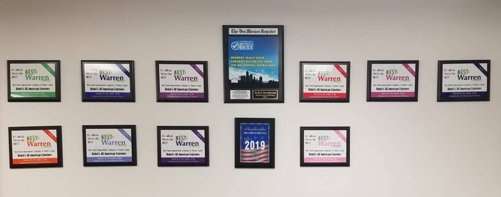 A wall displays multiple framed awards, including several “Best of Warren” certificates in different colors and a central plaque reading “Best of the Best,” as well as a framed 2019 American flag-themed certificate.